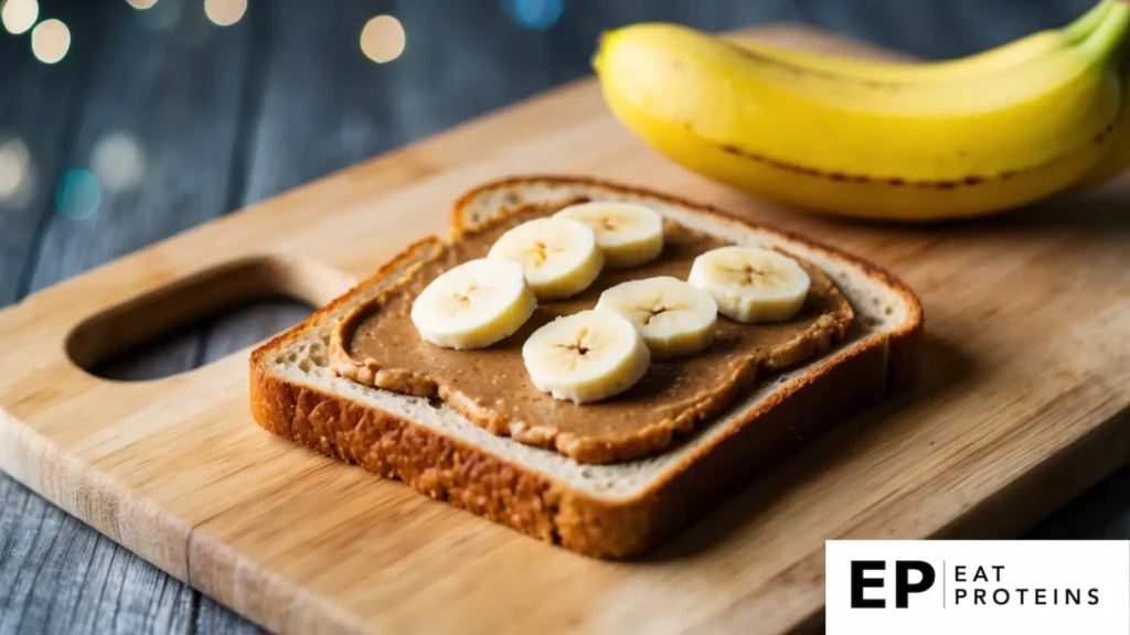 A slice of whole grain toast topped with a spread of almond butter and slices of ripe banana, sitting on a wooden cutting board