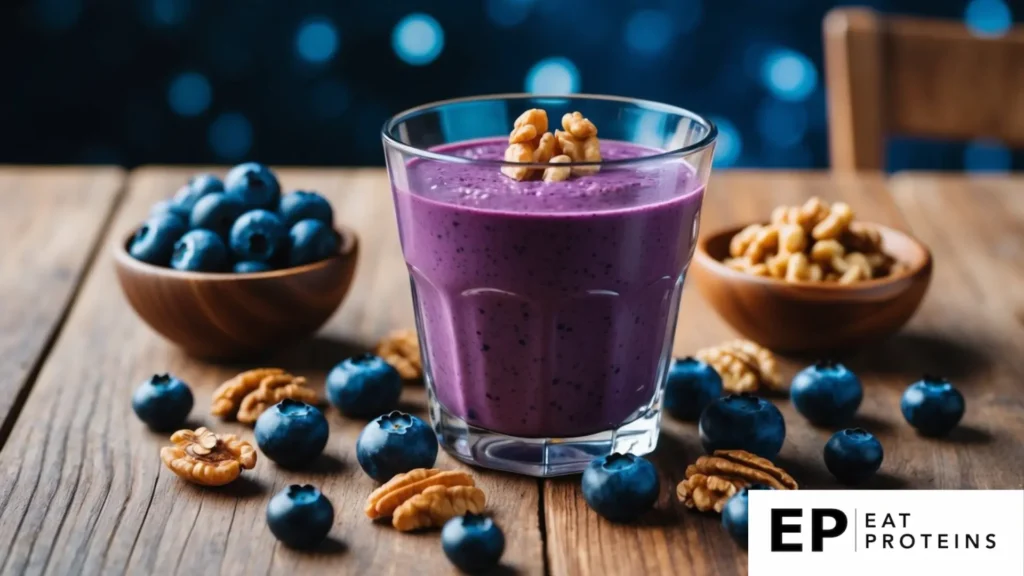 A glass filled with a vibrant blueberry walnut smoothie surrounded by fresh blueberries and walnuts on a wooden table