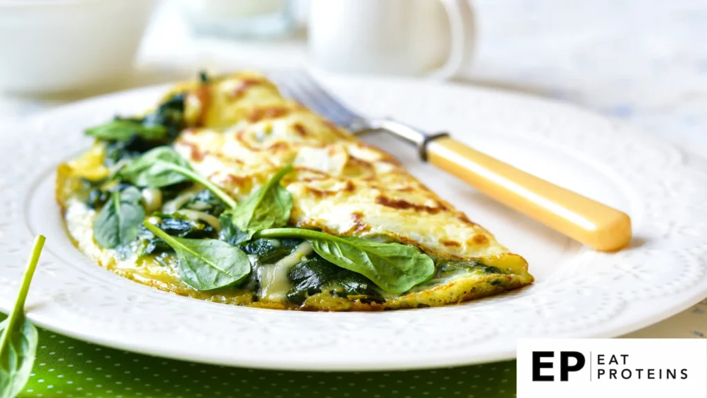 An egg white omelette with spinach and feta sizzling in a plate