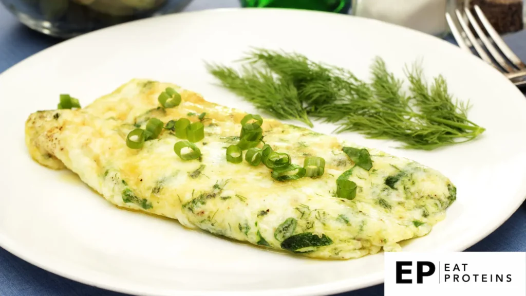 A sizzling egg white omelette with vibrant green spinach cooking in a non-stick skillet on a stovetop