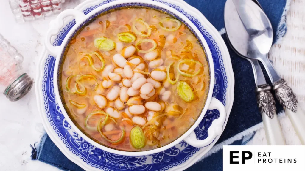 The image you uploaded appears to show a bowl of Greek Fasolada, a traditional bean soup. This dish is made with white beans, vegetables like carrots and leeks, and flavored with olive oil and herbs. Fasolada is often considered a "Blue Zone" recipe, highlighting its health benefits for longevity and well-being