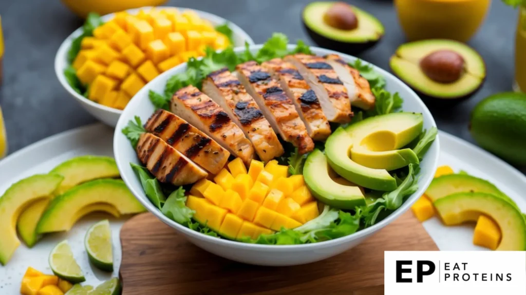 A colorful salad bowl with grilled chicken, mango, and avocado arranged in an appetizing display