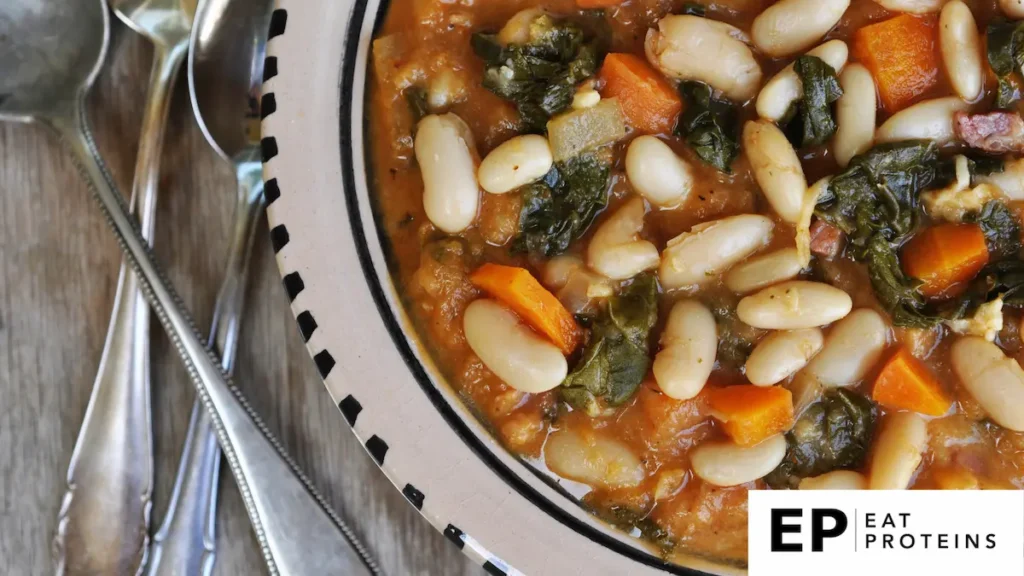 A colorful array of cooked vegetables simmering in a large pot on a stovetop, steam rising and filling the kitchen with savory aromas