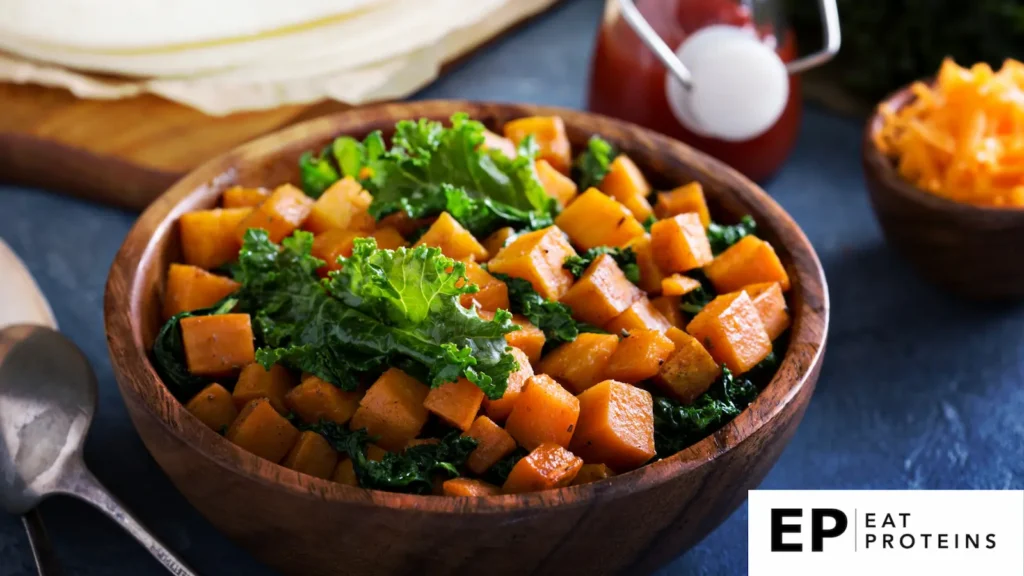 A colorful skillet sizzling with kale, sweet potatoes, and assorted vegetables