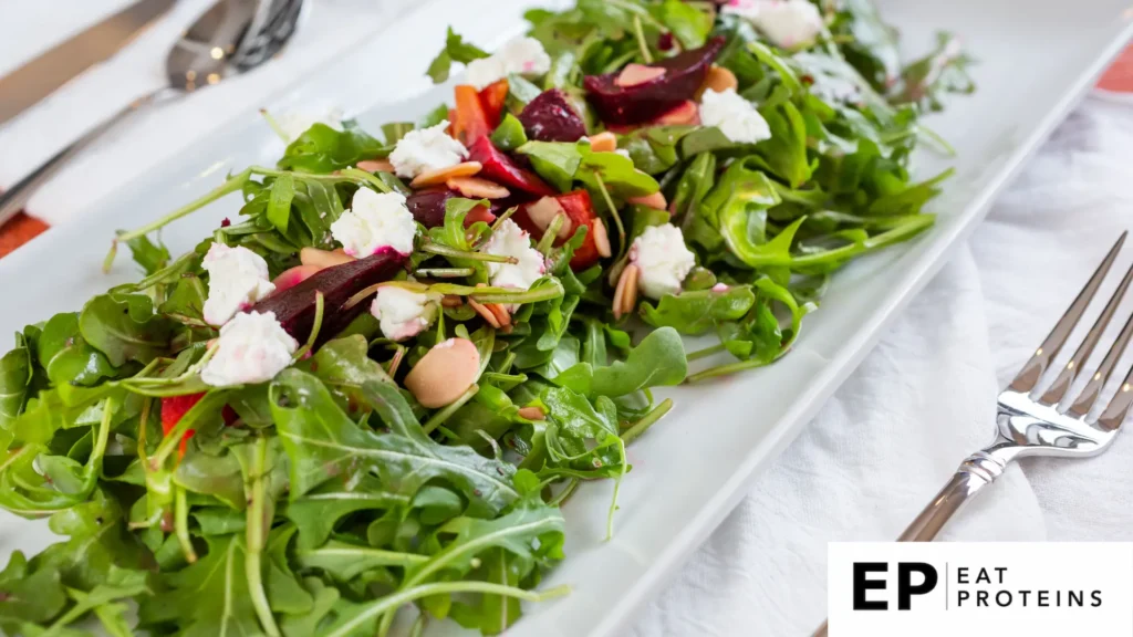 A colorful array of roasted beets, mixed greens, and nuts arranged on a plate