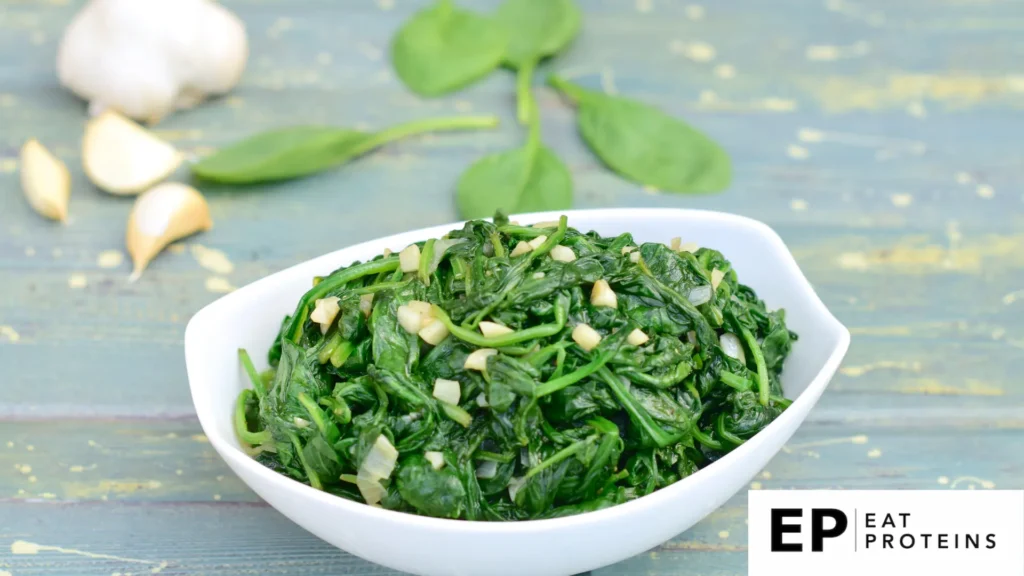 Fresh kale leaves sizzling in a pan with minced garlic, emitting a savory aroma