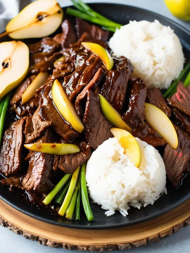 A sizzling pan of beef bulgogi cooking with sliced pears and marinade