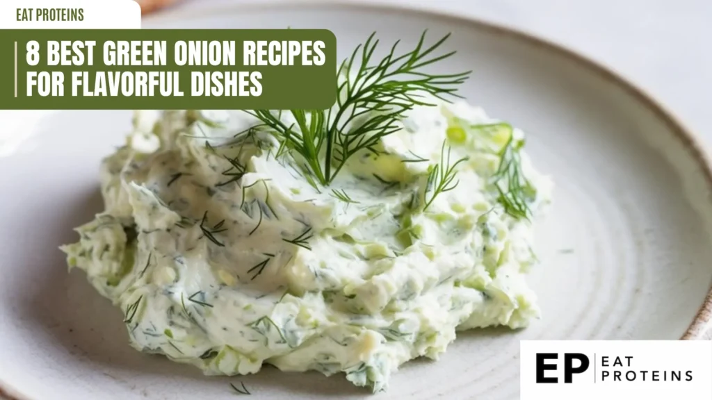 a creamy, light-green dip, possibly tzatziki with visible chopped green onions and dill, is presented on a white plate. a sprig of fresh dill adorns the top. the dip has a slightly chunky texture and appears refreshing